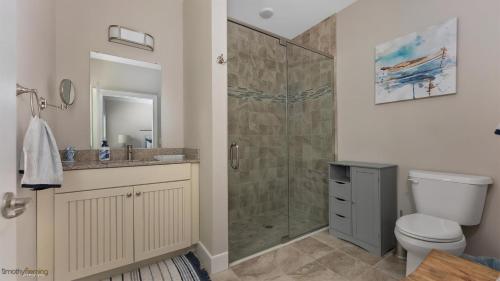 a bathroom with a shower and a toilet and a sink at Residence 201N At The Sandcastle Condominiums in Wildwood Crest