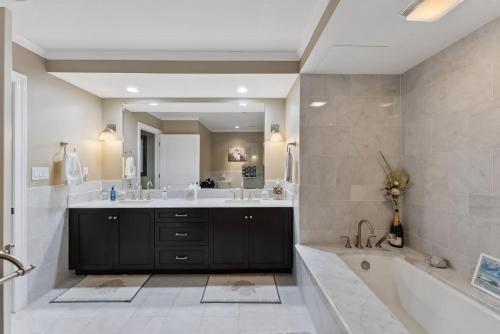 a bathroom with a large tub and a large mirror at Residence 409 At The Grand in Wildwood