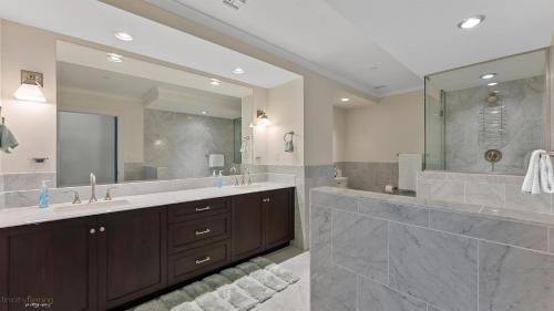 a bathroom with two sinks and a large mirror at Residence 902 At The Grand in Wildwood