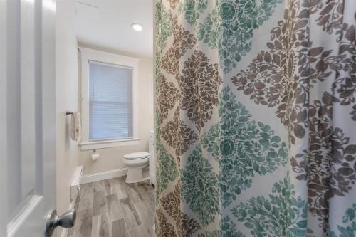 a bathroom with a toilet and a shower curtain at 5605 Seaview Ave, Unit G in Wildwood
