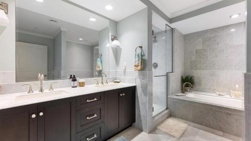 a bathroom with two sinks and a shower and a tub at Residence 1201 At The Grand in Wildwood