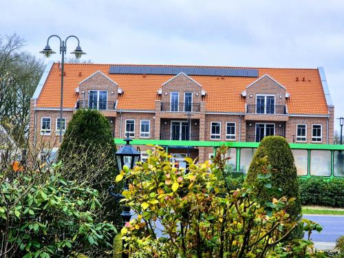 a large brick building with an orange roof at Schomaker Fatmann in Rastdorf