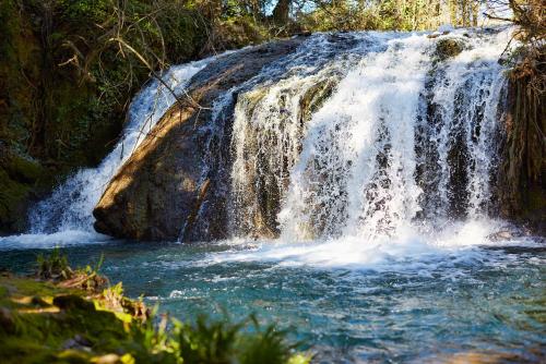 a waterfall in the middle of a river at Ferme Saint-Georges en Provence in Le Val