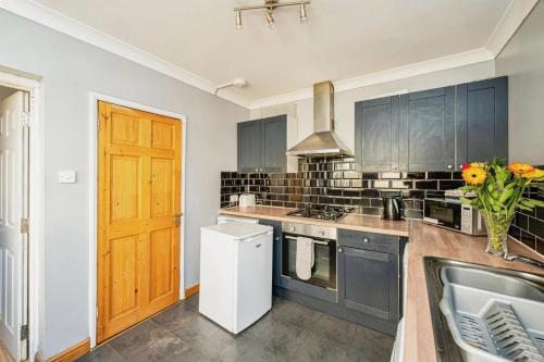 a kitchen with a sink and a stove top oven at 5 Bedroom House For Corporate Stays in Kettering in Kettering