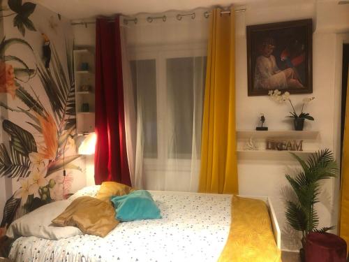 une chambre avec un lit avec deux oreillers dessus dans l'établissement United Colors Of Clermont, à Clermont-Ferrand