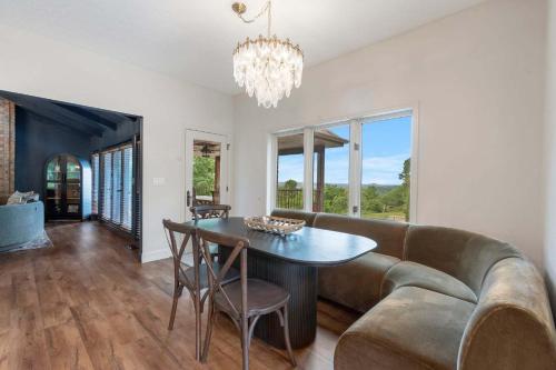 a living room with a couch and a table at Rolling Hills Family Home in Branson West