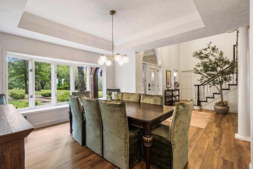 a dining room with a table and chairs at Rolling Hills Family Home in Branson West