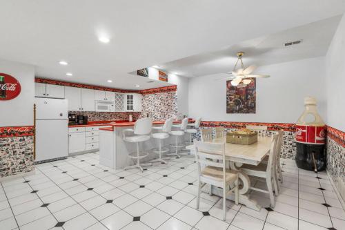 a kitchen with white cabinets and a table and chairs at Rolling Hills Family Home in Branson West