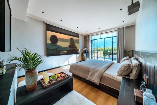 a bedroom with a bed and a large window at Forest B&B in Dali Ancient Town
