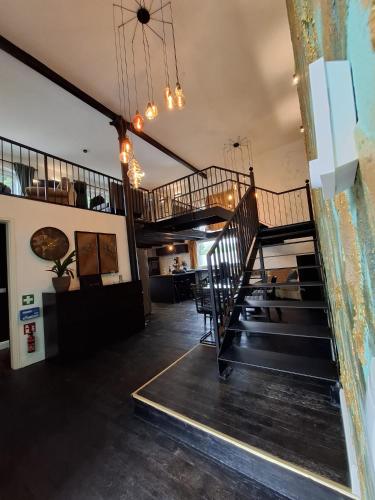 a room with a spiral staircase in a building at Bahnhofsoase - Wellness & Spa am Krufter Bahnhof in Kruft