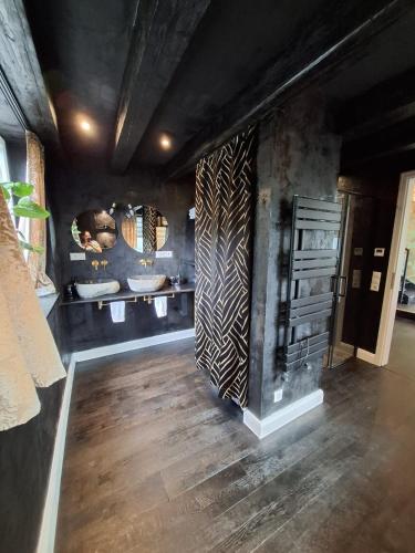 a bathroom with a wooden floor and a sink at Bahnhofsoase - Wellness & Spa am Krufter Bahnhof in Kruft