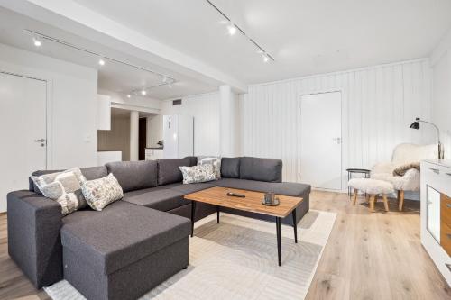 a living room with a couch and a table at Amazing view I Fjellheisen I FREE Parking in Tromsø