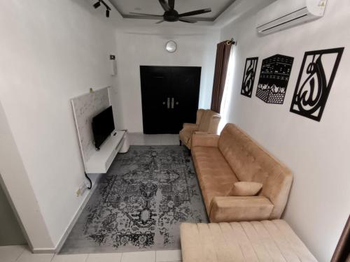 a living room with a couch and a ceiling fan at A&L NilamHomestay in Seremban