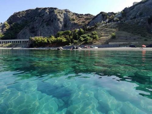 a view of a beach with turquoise water at Casa margherita in Bova Marina