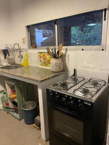 a kitchen with a stove and a counter top at Casa completa Balneario Argentino in Balneario Argentino
