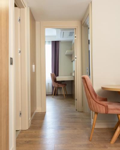 a hallway with a table and chairs in a room at Frezya - Exclusively Woman in Istanbul