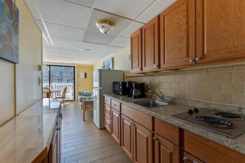 a kitchen with a sink and a refrigerator at 404 E Denver Ave, Unit 215 in Wildwood Crest