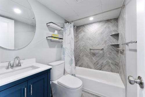 a bathroom with a sink and a toilet and a shower at 301 Ocean Ave, Unit 102 - The Harbor Light in North Wildwood