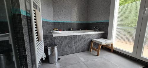 a bathroom with a sink and a bath tub at Maison design aux portes de Paris in Puteaux