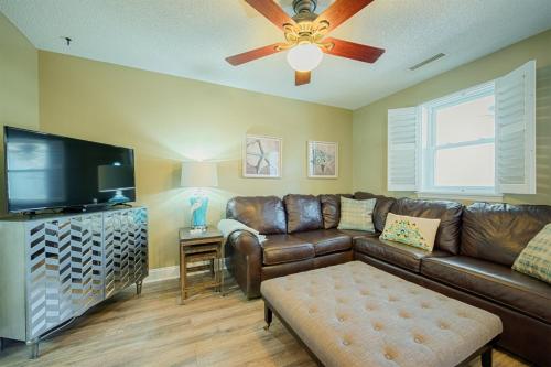a living room with a couch and a flat screen tv at Windy Hill Villa 1 - Beach Barnacle in Myrtle Beach