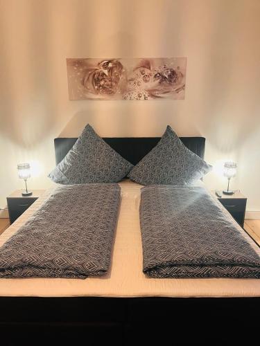a bed with two pillows on top of it at FeWo Beatles Platz Reeperbahn Ecke Große Freiheit in Hamburg