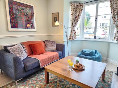 a living room with a couch and a coffee table at Elegant 3BR Home Near Oxford Centre, Garden, WiFi in Oxford