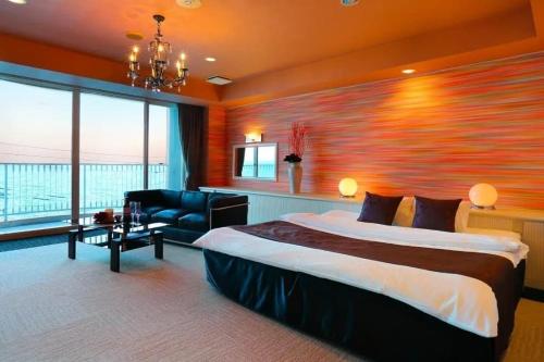 a hotel room with a bed and a large window at HOTEL CALM - Couple's Hotel in Beppu