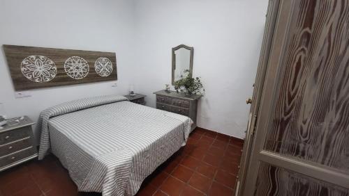 a bedroom with a bed and a dresser and a mirror at Buenavista in Ayamonte