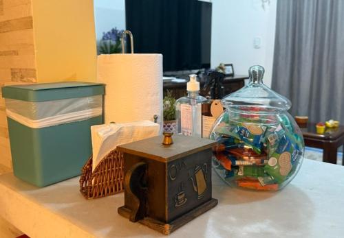 a table with a glass jar with a fish in it at Casa Jardim in Miguel Pereira