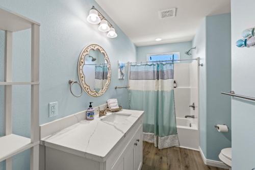 a bathroom with a sink and a mirror at Gorgeous 4BD with Hot Tub, Golf Cart, Deck, Gourmet Kitchen in Gilchrist