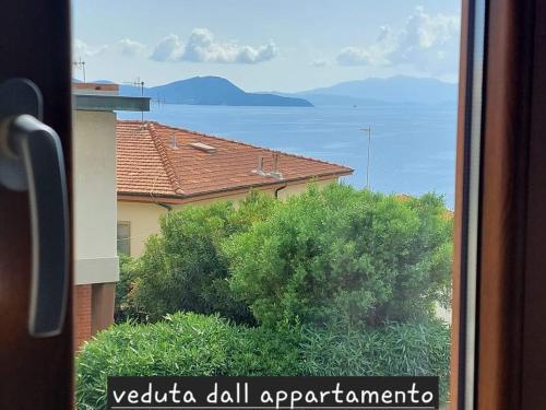 a view of the ocean from a window of a building at Appartamento Perla di Mare in Piombino