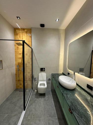 a bathroom with a toilet and a sink and a shower at Sea breeze PR2 in Nardaran