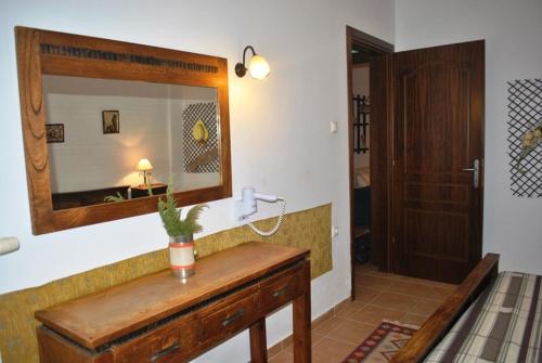 a bathroom with a mirror and a wooden table at Archondissa Beach Aparthotel in Therma