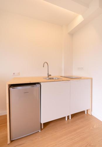 a kitchen with a sink and a counter at UMI surf yoga house Doniños beach in Ferrol