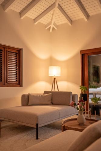 a living room with a couch and a table at Villa Shelu in Willibrordus