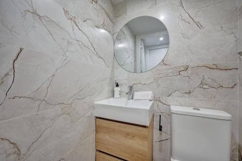 a bathroom with a white sink and a mirror at La Pequeña Gran Casa by Clabao in Viana