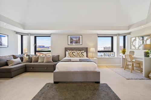 a living room with a bed and a couch at Waterfront Penthouse with Balcony & Parking in Liverpool