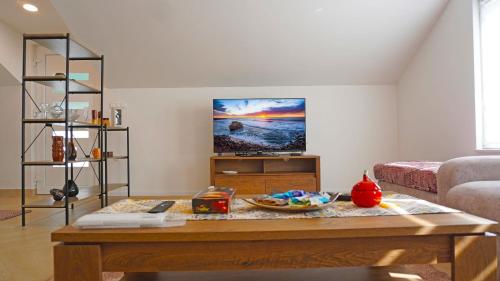 a living room with a coffee table and a flat screen tv at Twins Land in Mostar