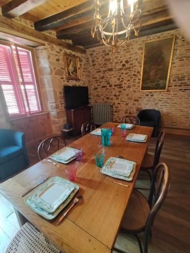 a dining room with a wooden table with chairs at maison médiéval pour six personnes in Saint-Benoît-du-Sault