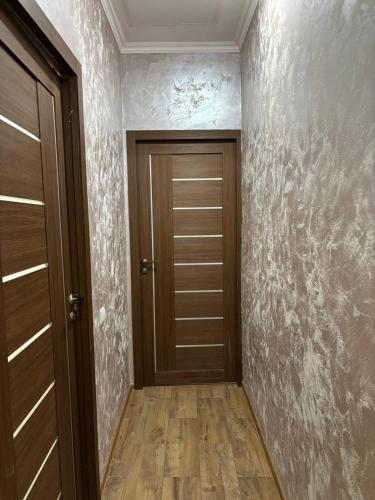a hallway with a wooden door in a room at DS Appartment in Yerevan in Yerevan