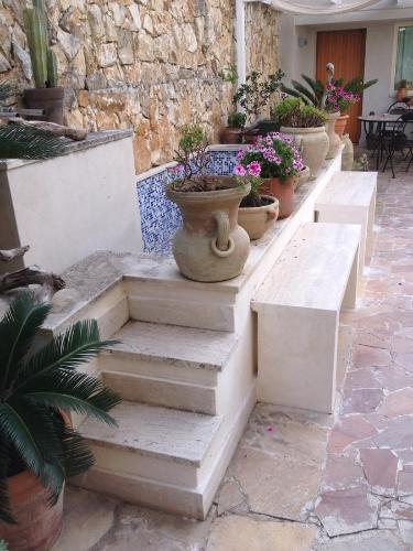 a row of stairs with potted plants on them at Il Giardino Dei Limoni in Aci Castello