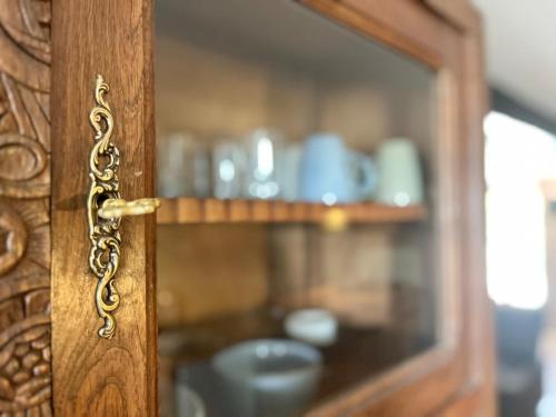 a close up of a wooden door with a glass window at Gîte "La belle vie" in Chamblet