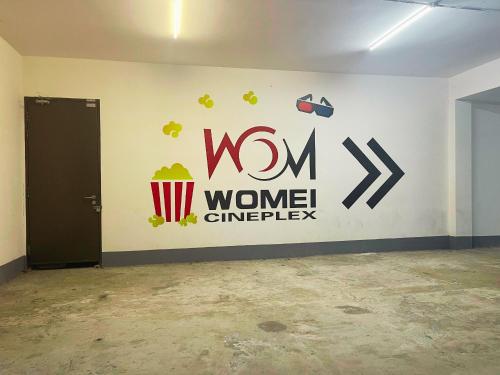 a wall with a wenn sign on it at JB Danga Bay Cozy 2BR by Viesel Group - Netflix, WiFi, Free Parking in Johor Bahru