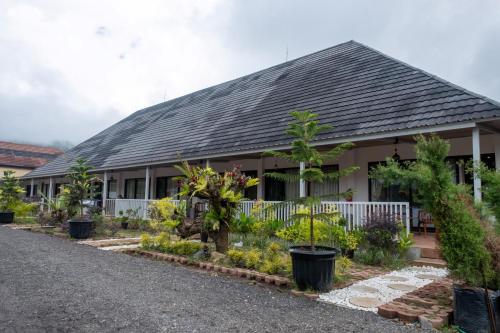 a house with trees and plants in front of it at Asri Rinjani Hotel in Sembalun Lawang