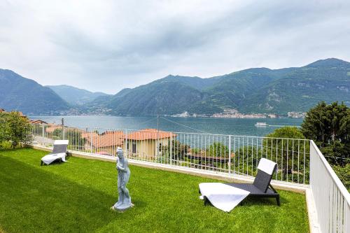 a balcony with a view of the water and mountains at Spa Stella Lario in Lezzeno