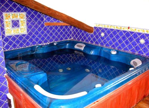 a blue tub in a blue tiled bathroom at Monastery Biribino in Città di Castello