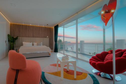 a bedroom with a bed and a large window at Hi Yang Seaview Villa in North Pattaya