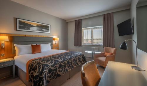 a hotel room with a bed and a desk and a chair at Clayton Hotel & Leisure Club Sligo in Sligo