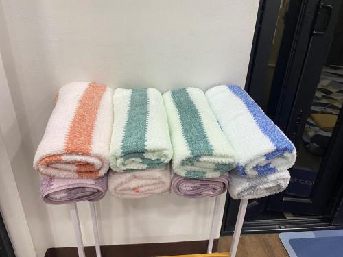 a bunch of towels on sticks in a room at Peaceful Port Away From Home in Manila