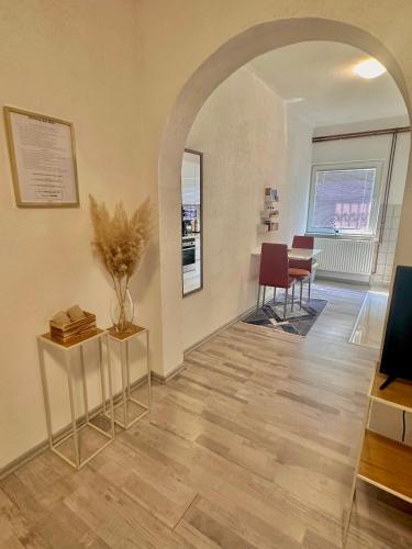 a hallway with an archway and a table and chairs at Apartment Rea Ilidža 2 in Sarajevo